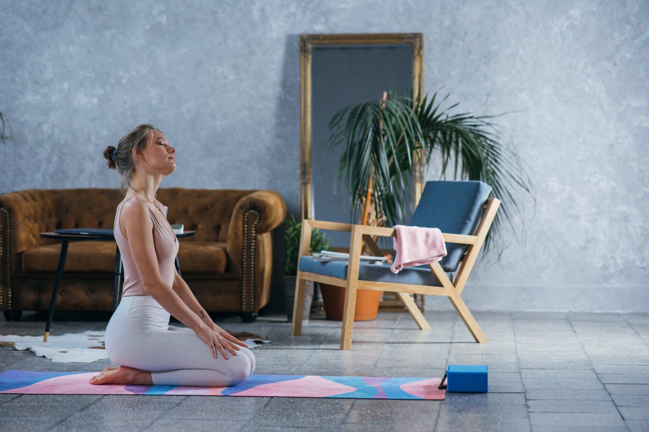 A woman meditates in a peaceful indoor setting, promoting wellness and healthy living.